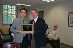 DYilin Hou, former President of CAAPA, presenting the service recognition award to William Sullivan, Assistant Dean for External Relations of the Maxwell School of Syracuse University at the 2010 Omaha conference.